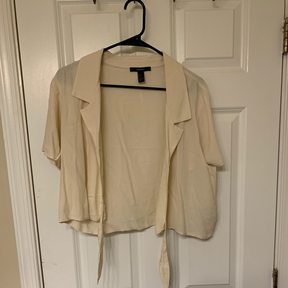 A beige, lightweight crop tie with tie front. - Picture 1 of 2